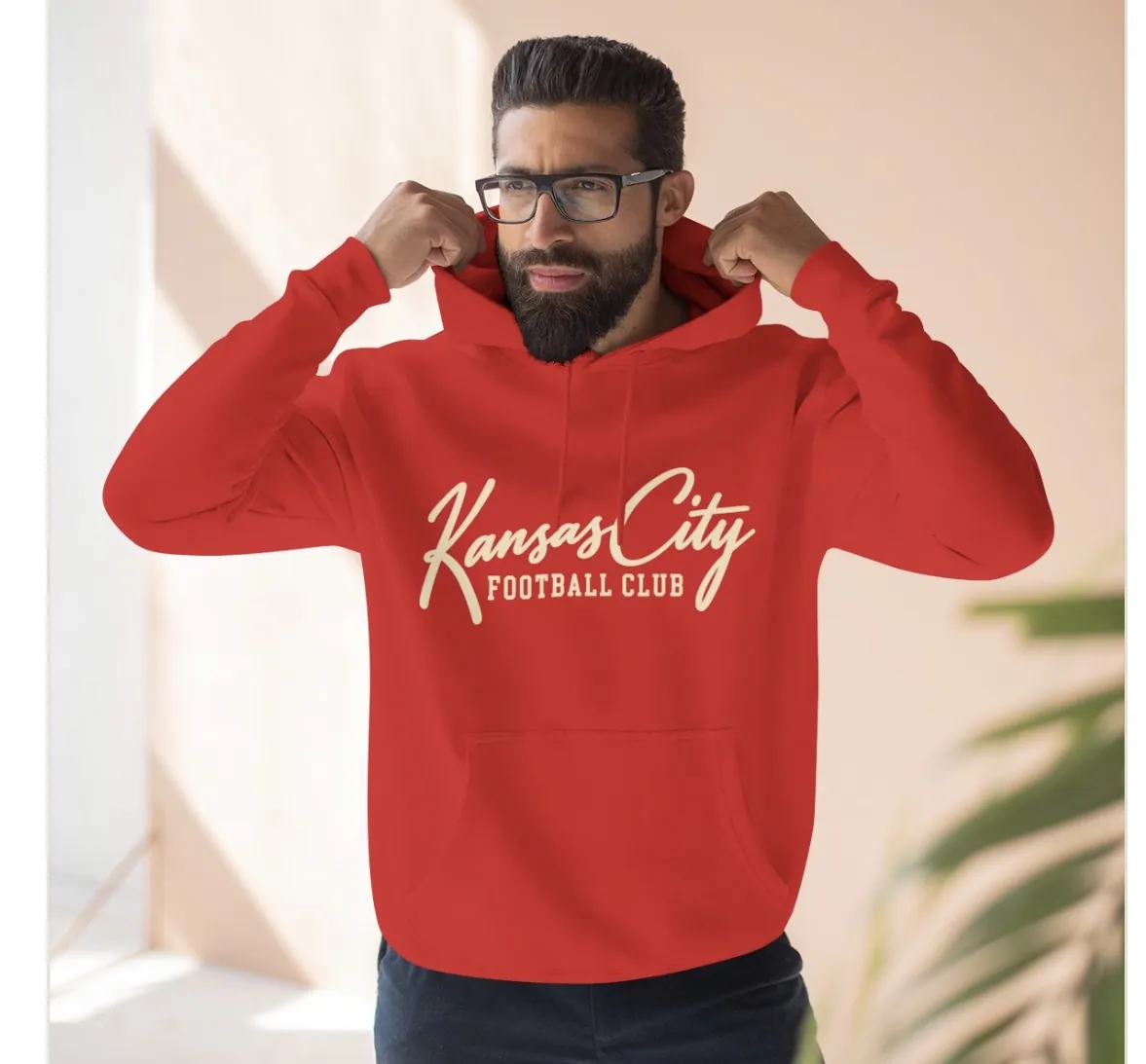 Kansas City Football Club Hoodie in Red, on a model
